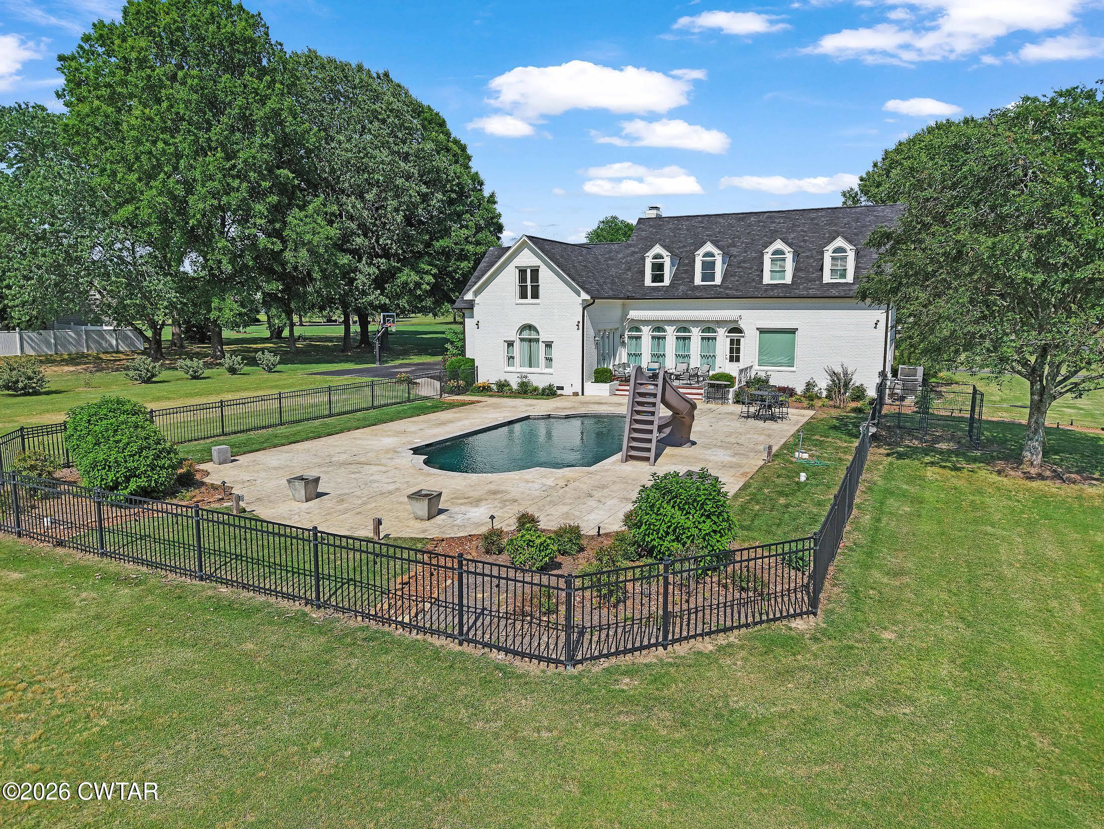58 Huntington Place Jackson, TN 38305 - Photo 5 of 38 a view of a house with pool and a yard