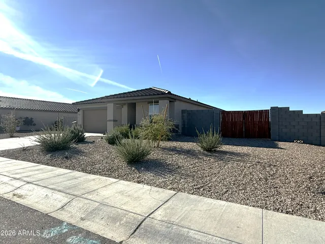 a view of a house with wooden fence