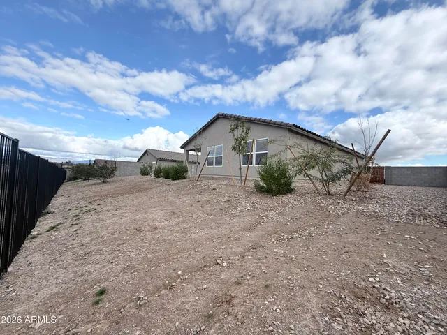 a view of a house with a dry yard and covered with snow