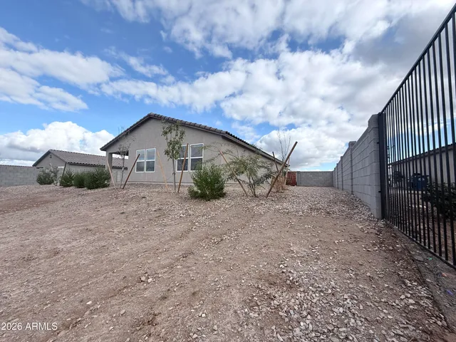 a view of a house with backyard and barbeque area