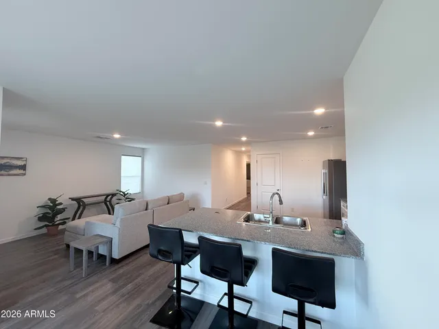 a living room with lots of furniture and wooden floor