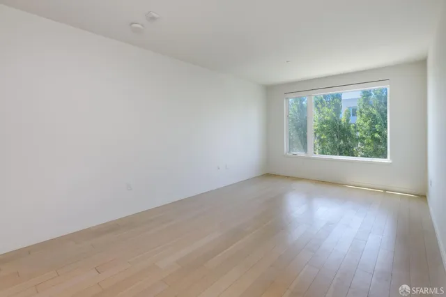 a view of a kitchen with wooden floor and a sink