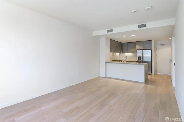 a large kitchen with stainless steel appliances a large counter top