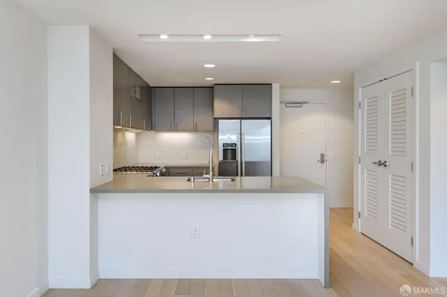 a kitchen with a sink and stainless steel appliances