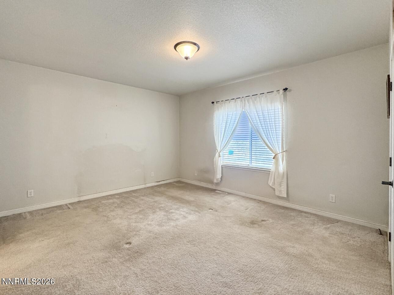 5695 Mote Road Battle Mountain, NV 89820 - Photo 11 of 16 an empty room with a empty space and windows