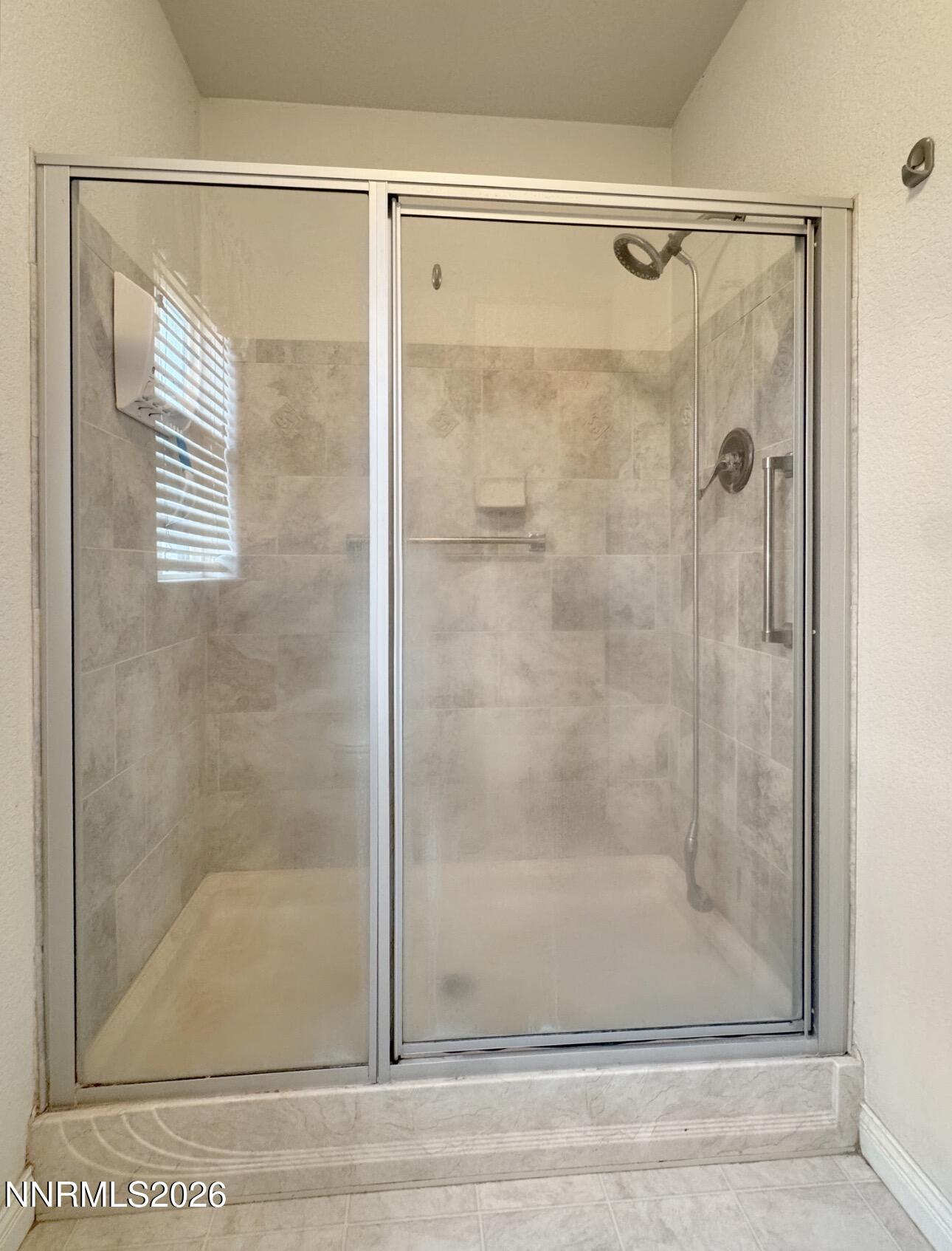 5695 Mote Road Battle Mountain, NV 89820 - Photo 13 of 16 a bathroom with a glass shower door