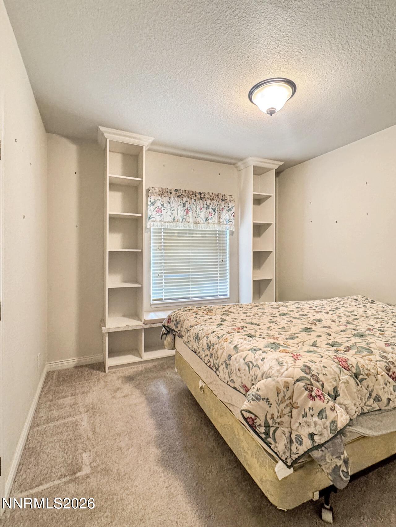 5695 Mote Road Battle Mountain, NV 89820 - Photo 14 of 16 a bed sitting in a bedroom next to a window