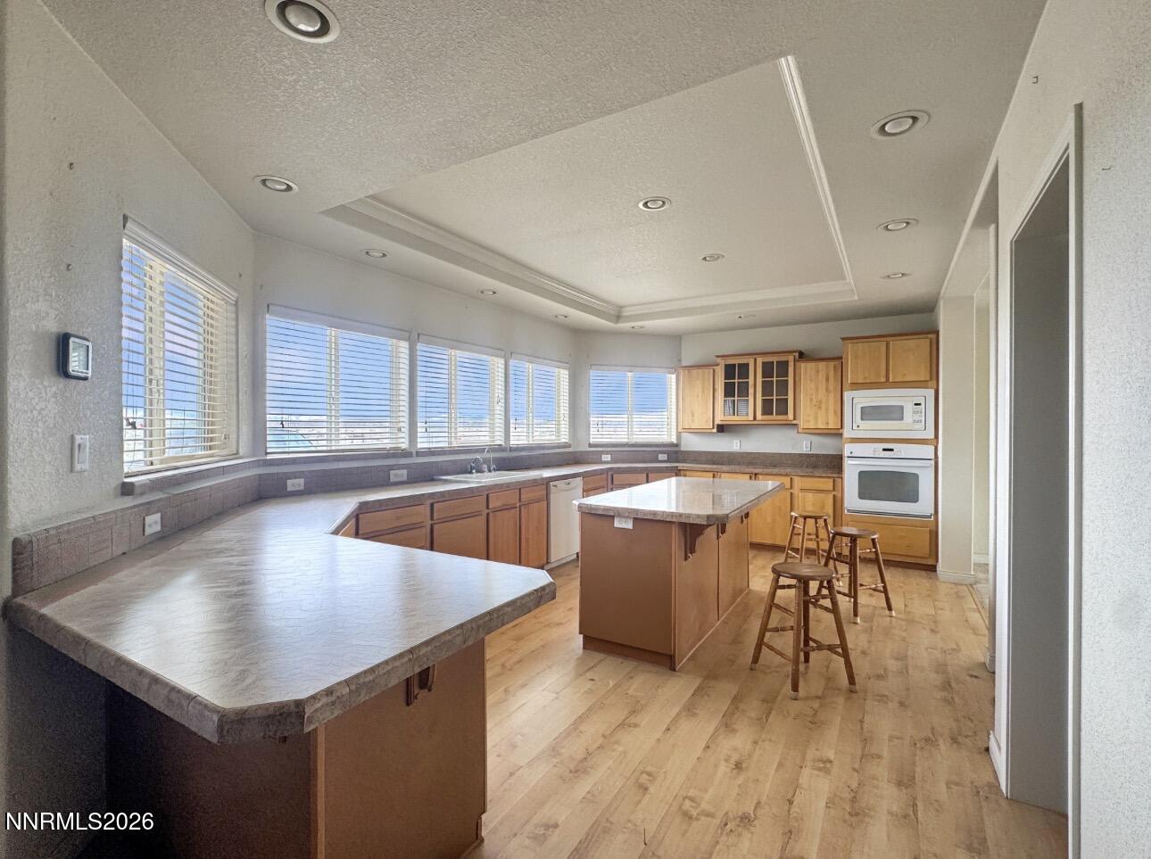 5695 Mote Road Battle Mountain, NV 89820 - Photo 10 of 16 a kitchen with stainless steel appliances granite countertop a sink a window and wooden floor