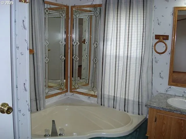 a bathroom with a tub and a shower