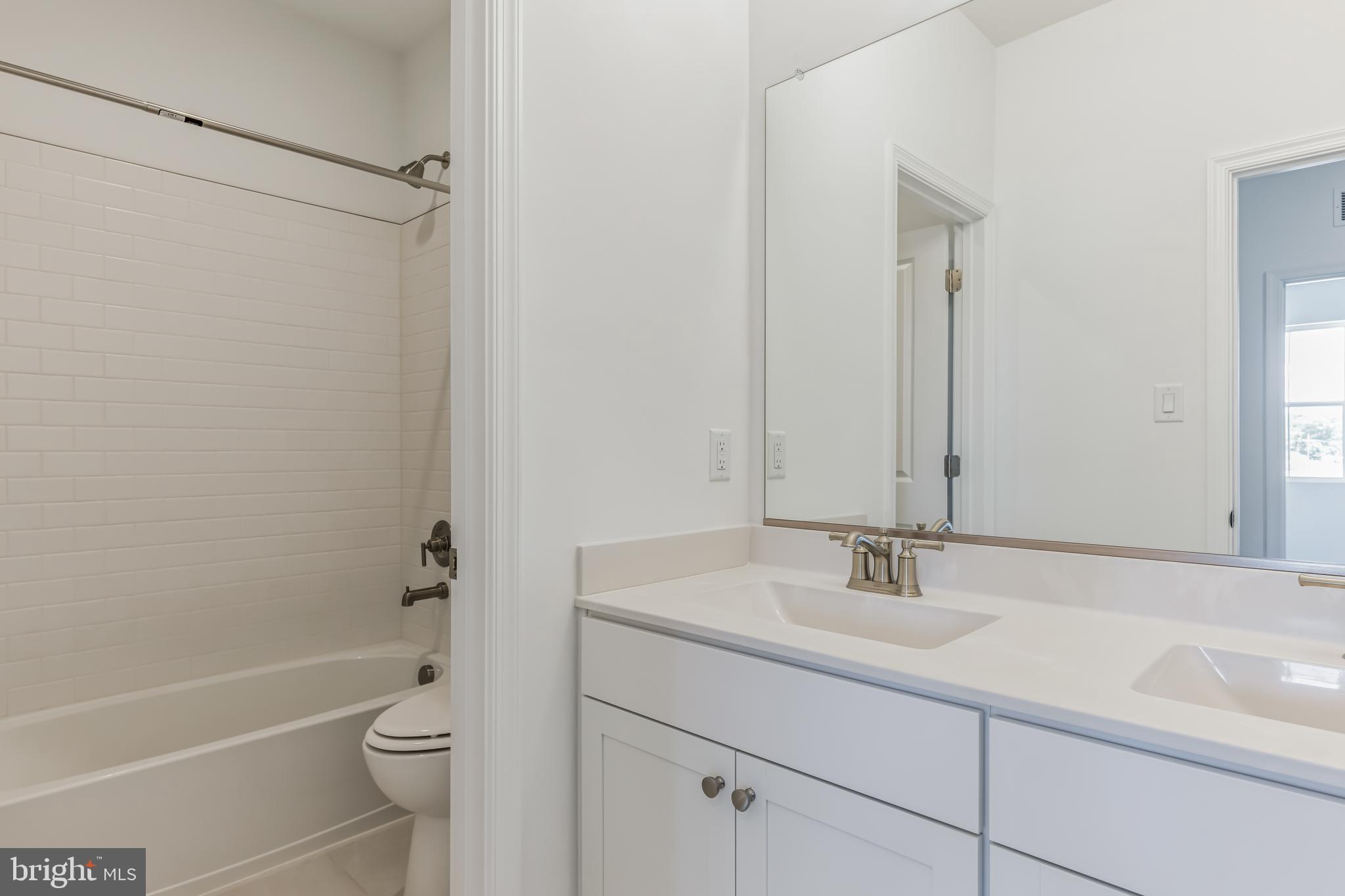 36319 Gate Drive Georgetown, DE 19947 - Photo 12 of 28 a bathroom with a sink toilet and shower