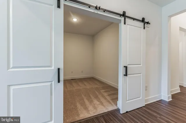 a view of a room with wooden floor
