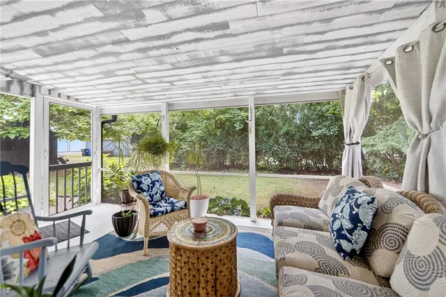 a living room with furniture and floor to ceiling windows