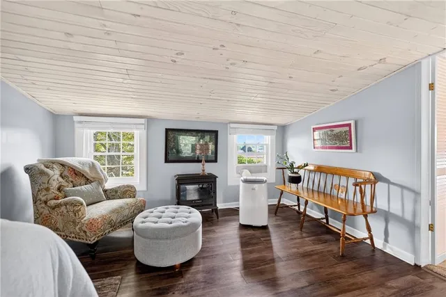 a living room with furniture a fireplace and a large window