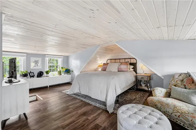 a bedroom with furniture and wooden floor