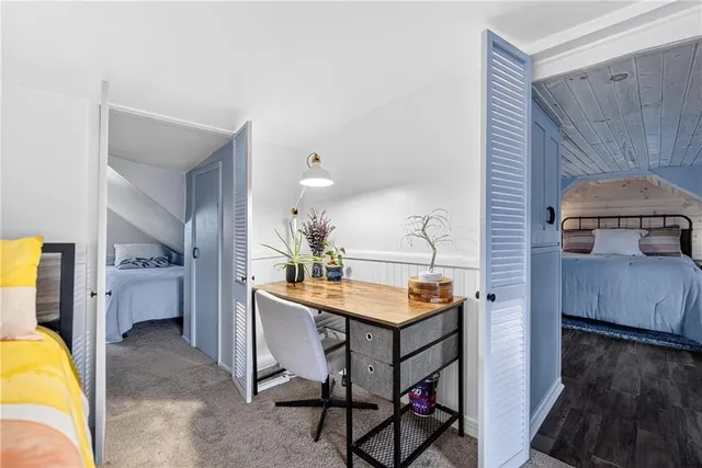 a view of a kitchen area with furniture and wooden floor