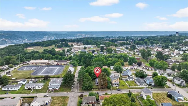 a view of a house with a backyard and garden