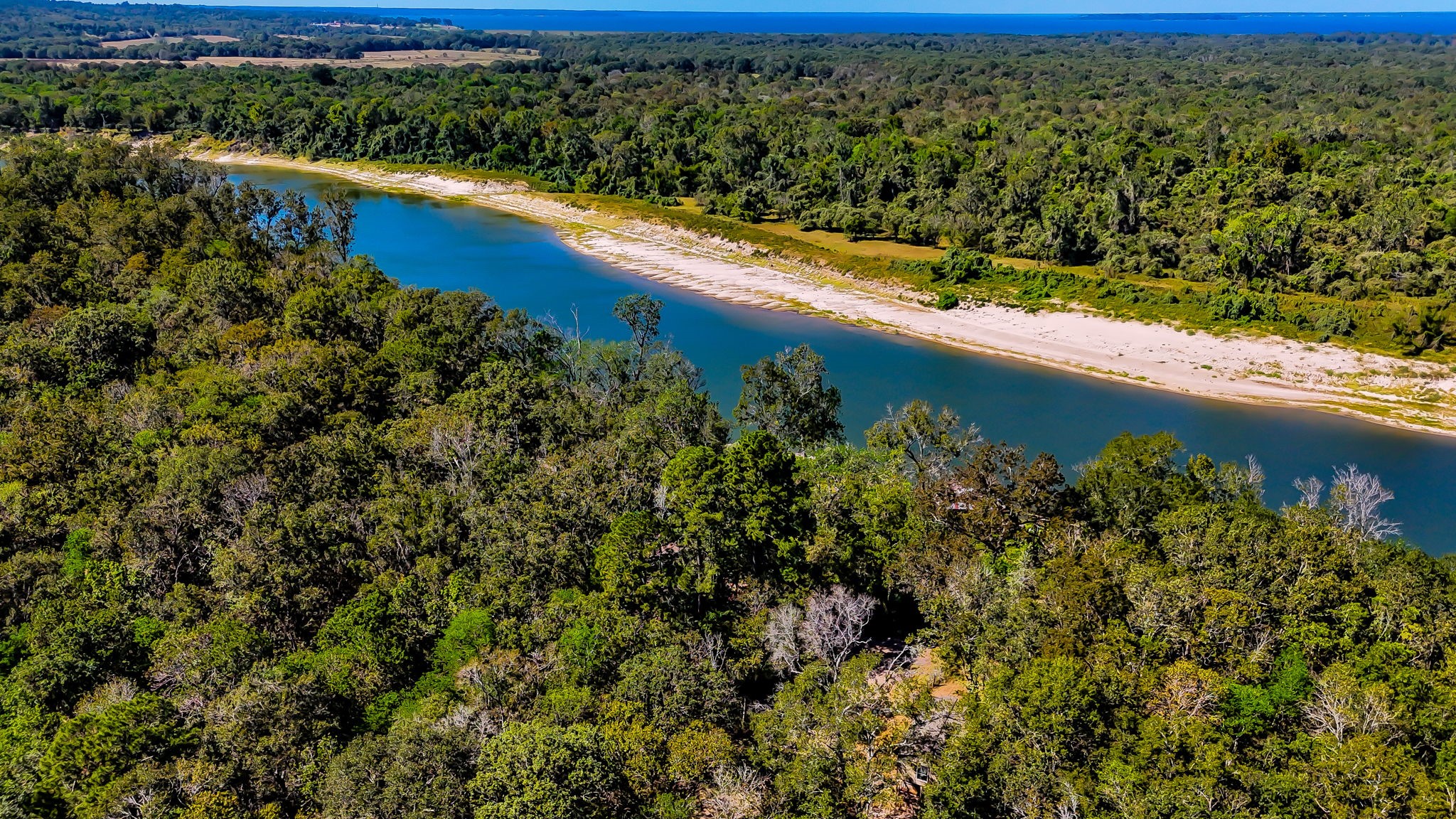 614 River Lakes Road Goodrich, TX 77335 - Photo 8 of 10 a view of a lake with a yard
