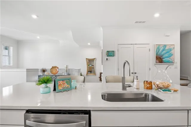 a kitchen with a sink stove and cabinets