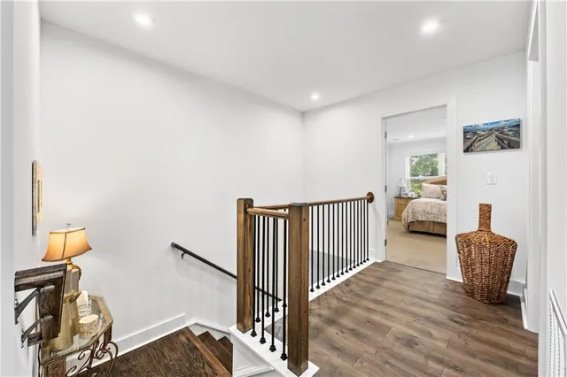 a spacious bedroom with a bed and a flat screen tv