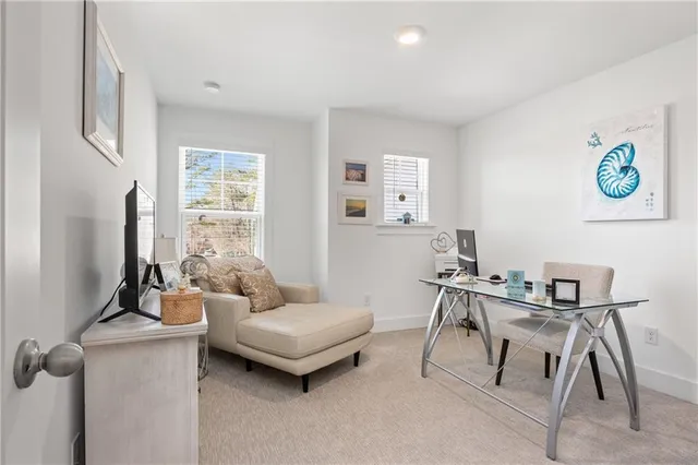 a bedroom with a bed lamp and a window