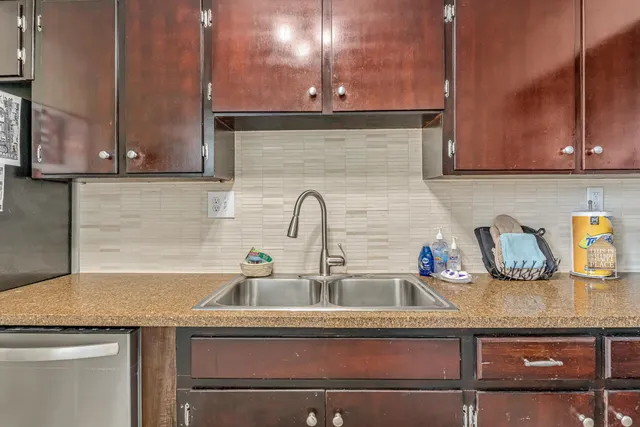 a kitchen with a refrigerator and a sink