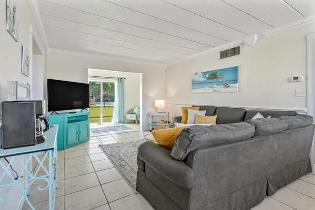 a kitchen with a chandelier a sink cabinets and appliances