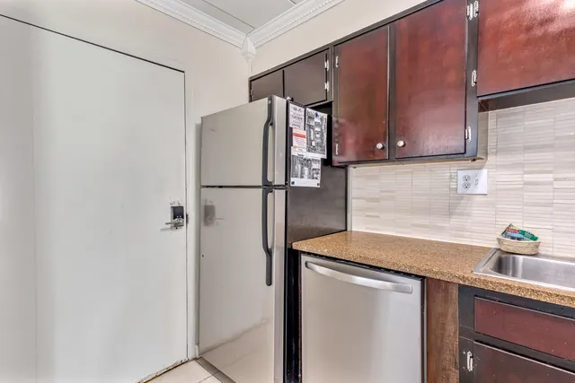 a kitchen with a sink cabinets and stainless steel appliances