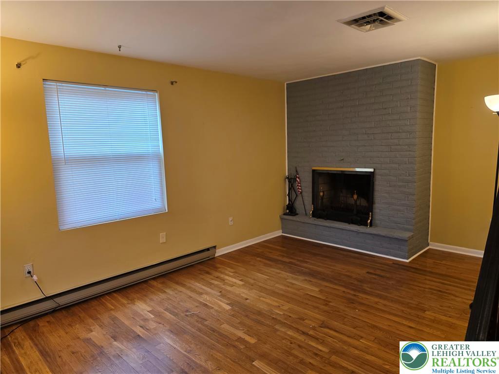 127 East Lynnwood Street Allentown, PA 18103 - Photo 19 of 34 a view of an empty room with wooden floor and a fireplace