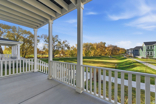 1038 South Old Towne Road Layton, UT 84041 - Photo 32 of 39 Covered porch with white railings and columns, providing outdoor living space
