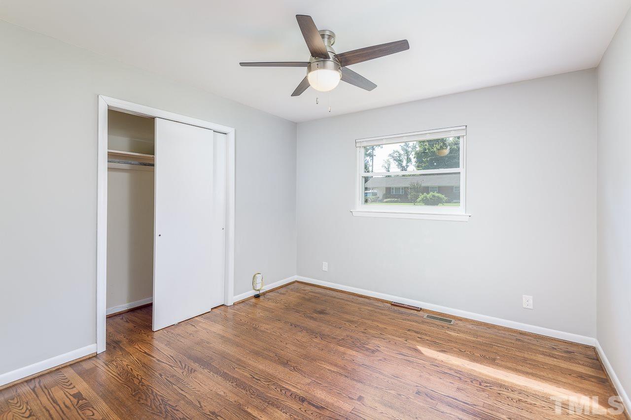4105 Suitt Road Durham, NC 27703 - Photo 11 of 15 an empty room with wooden floor and windows