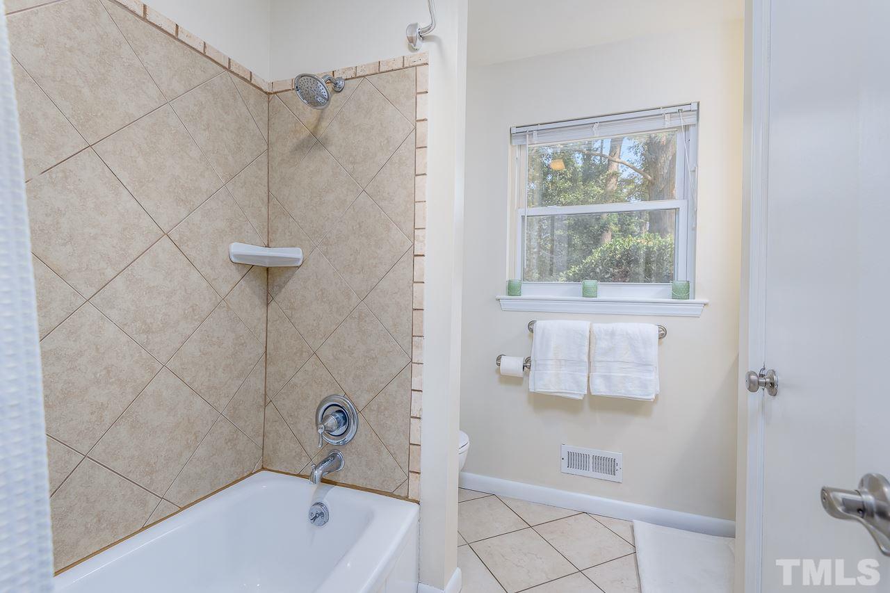 4105 Suitt Road Durham, NC 27703 - Photo 12 of 15 a bathroom with a bath tub with a shower