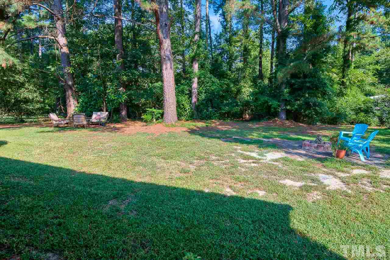 4105 Suitt Road Durham, NC 27703 - Photo 15 of 15 a view of a playground with a slide and large trees