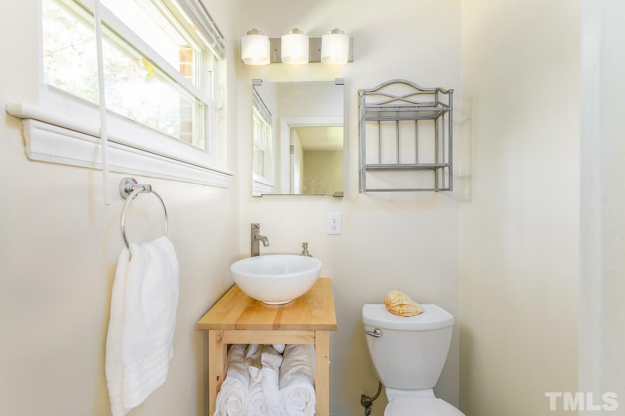 4105 Suitt Road Durham, NC 27703 - Photo 9 of 15 a bathroom with a toilet sink and mirror