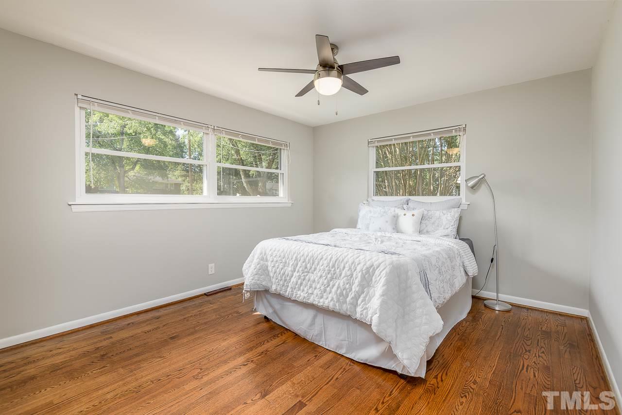 4105 Suitt Road Durham, NC 27703 - Photo 10 of 15 a spacious bedroom with a bed and wooden floor
