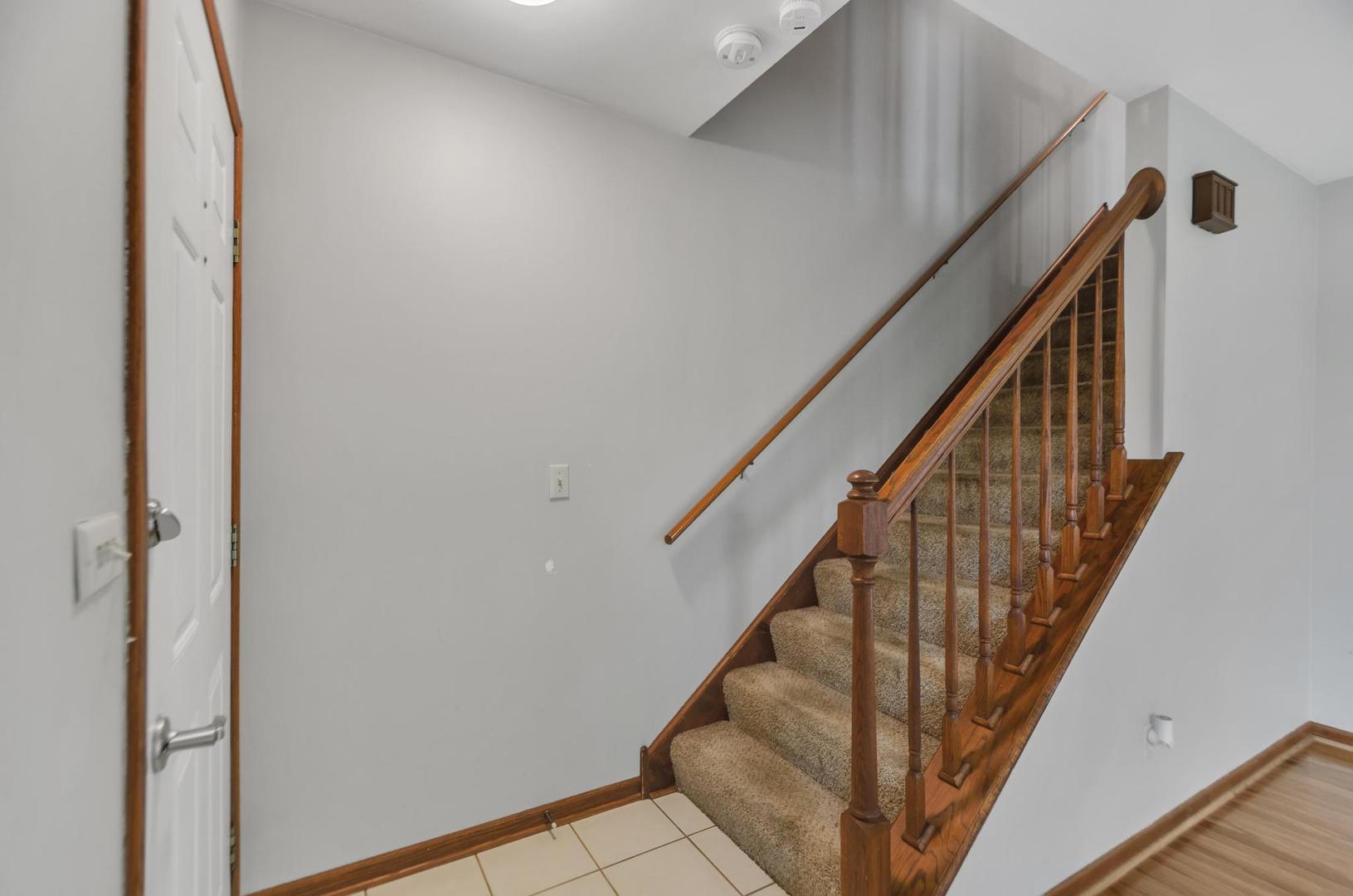 722 Sojourn Road New Lenox, IL 60451 - Photo 17 of 23 a view of staircase with wooden floor and white walls
