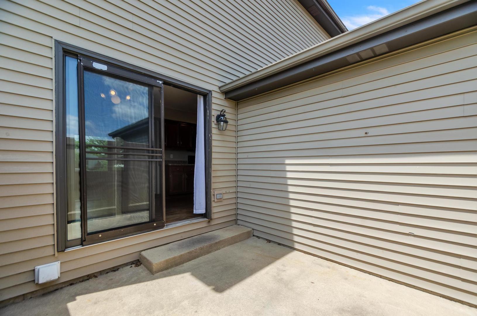 722 Sojourn Road New Lenox, IL 60451 - Photo 22 of 23 a view of a brick house with a large window