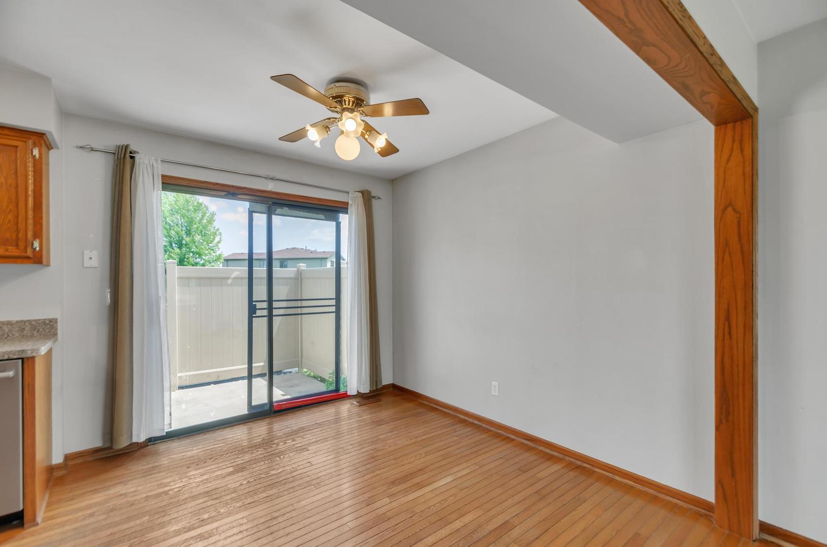 722 Sojourn Road New Lenox, IL 60451 - Photo 6 of 23 a view of an empty room with wooden floor and a window