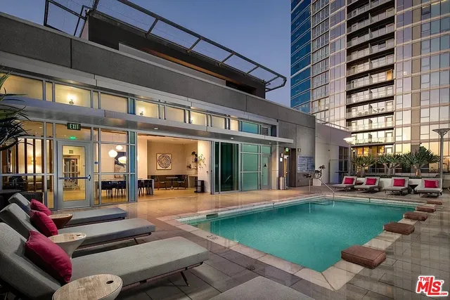 a view of a building with a swimming pool outdoor seating