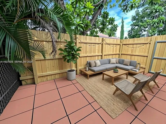 a backyard of a house with glass top table and chairs