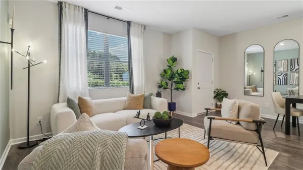 a living room with furniture potted plant and a window