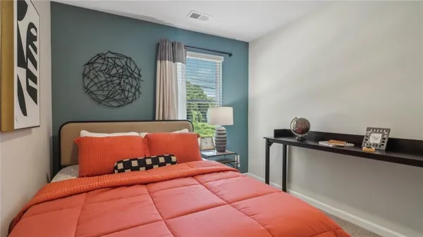 a bedroom with a bed and window
