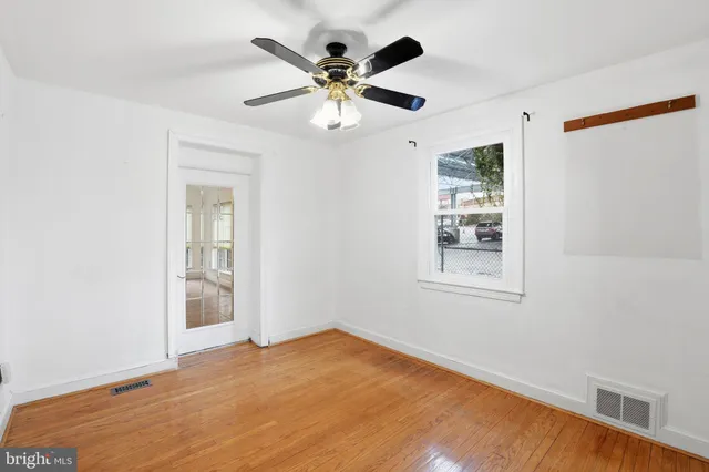 wooden floor in an empty room with a window