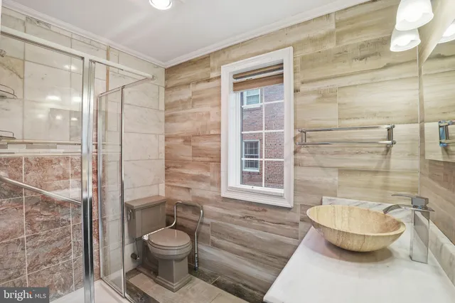 a bathroom with a toilet and a shower