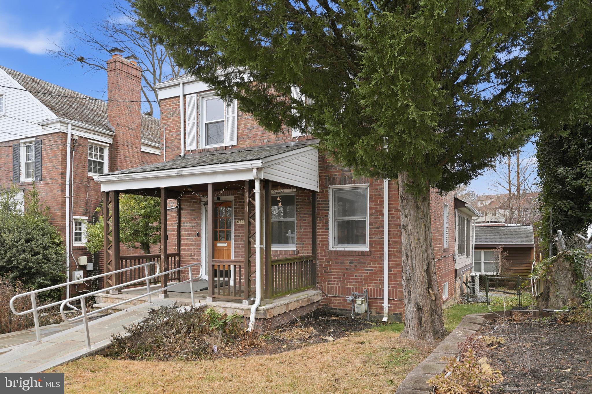 6758 Eastern Avenue Northwest Washington, DC 20012 - Photo 2 of 35 a front view of a house with a tree