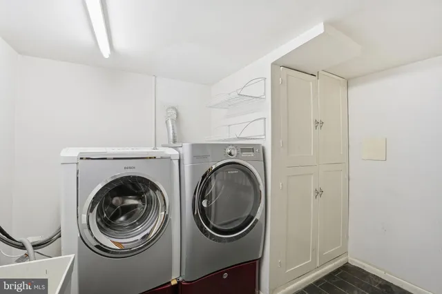 a utility room with sink dryer and washer
