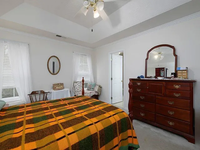 a bedroom with a bed and a dresser