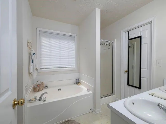 a bathroom with a tub and a sink