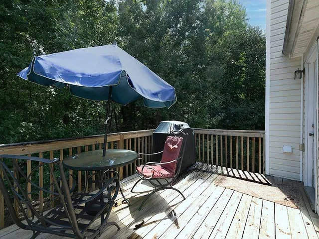 a view of a wooden deck with furniture