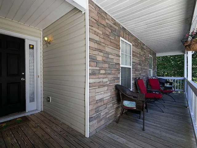 a view of a balcony with chairs and wooden floor