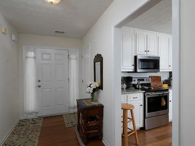 a kitchen with stainless steel appliances granite countertop a stove and a refrigerator